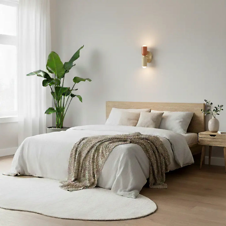 Retro wall lamp in coral and cream above a bed