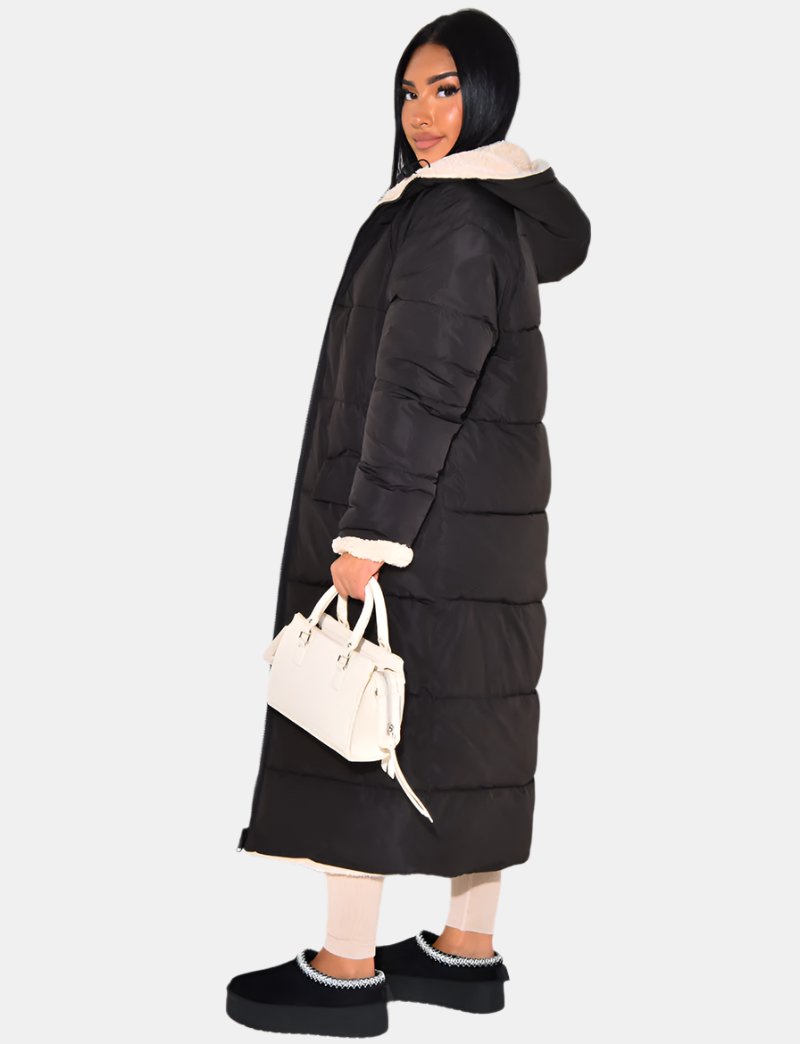 Women's reversible hooded long puffer coat, black quilted side in side view