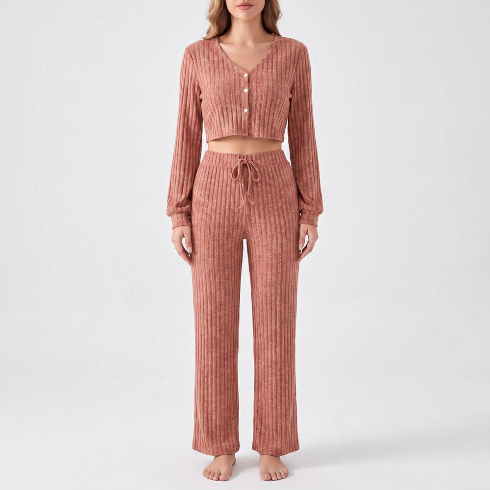 Front view of the terracotta ribbed knit set on a model against a plain light backdrop, showing buttons, drawstring waist and cuffs. 2