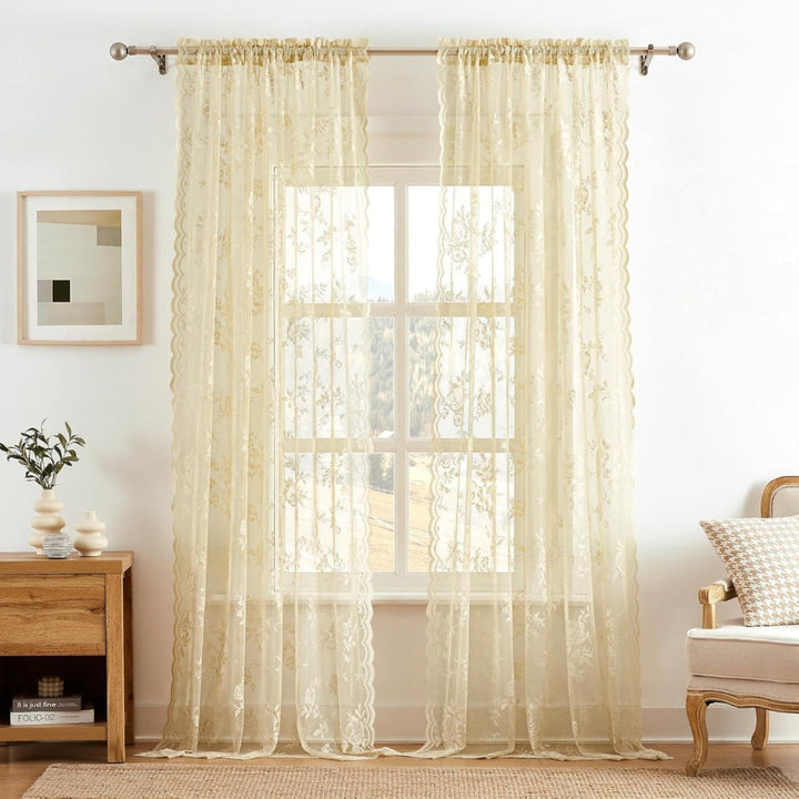 Cream floral lace panels hang from a metal rod with a rod pocket top, letting daylight through a large window.