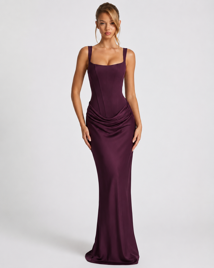 Dark plum satin maxi dress with a seamed corset bodice and draped hip, front view.