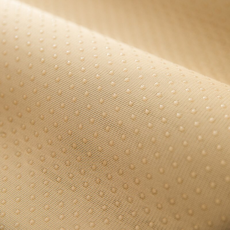 Close-up of the beige underside with small rubber grip dots.