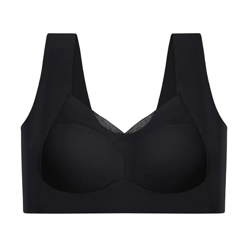 Black bra laid flat, front view with molded cups, mesh-trimmed V-neckline, and wide shoulder straps.