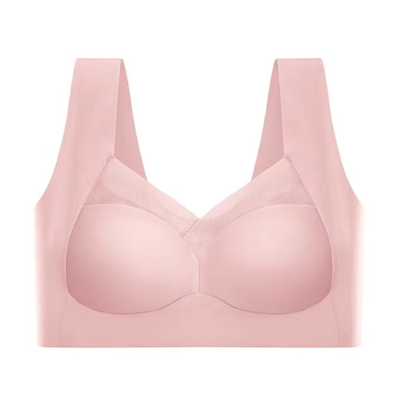 Pink bra laid flat, front view with molded cups, mesh-trimmed V-neckline, and wide shoulder straps.