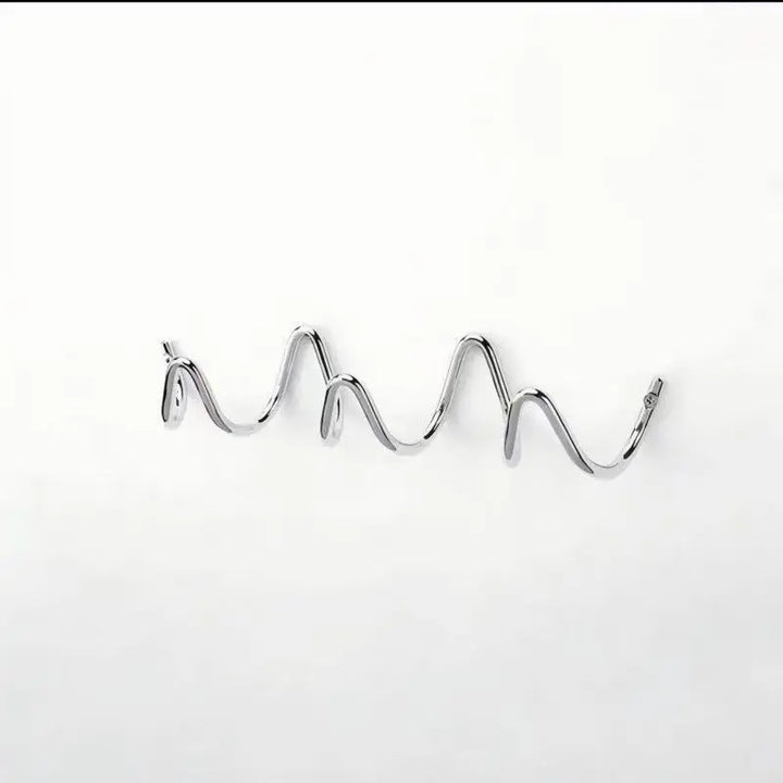 Silver metal wall rack shown alone against a white background.