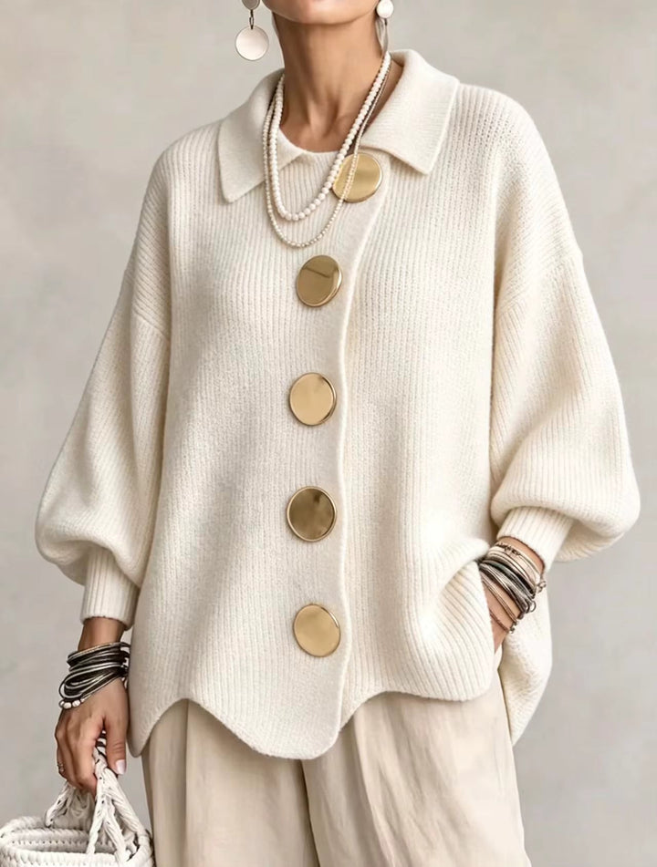 Cream white ribbed knit cardigan with puffed sleeves and large gold buttons on a model.