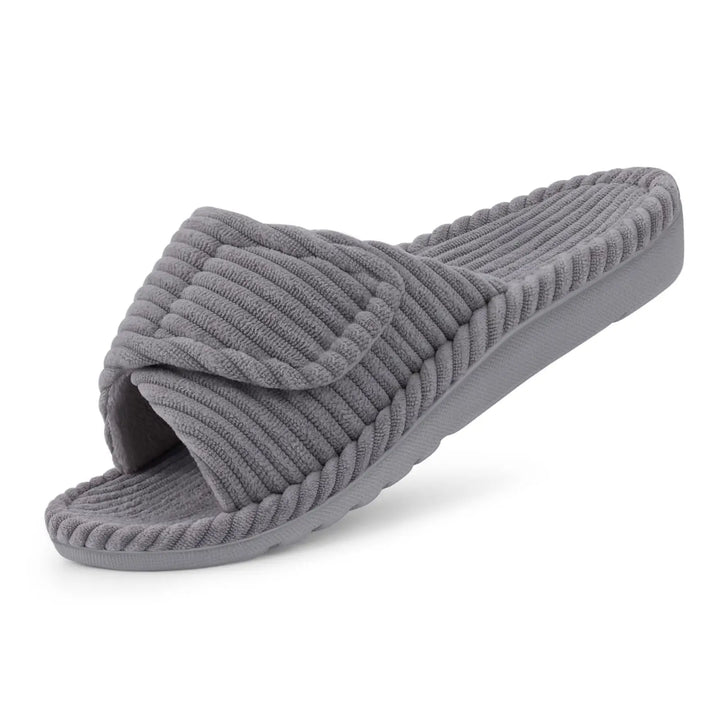 Gray ribbed corduroy open-toe slide slipper with a folded-over adjustable strap, shown at an angle on a white background.