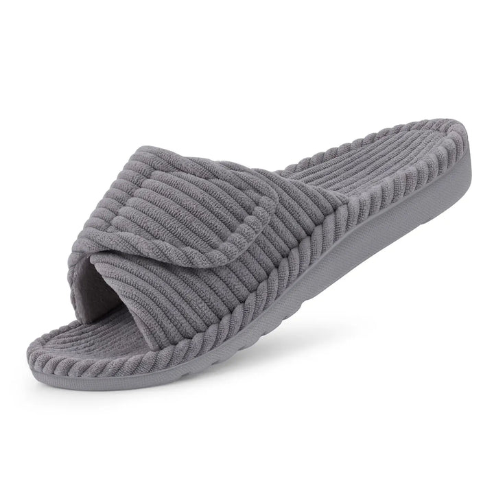 Gray ribbed corduroy slide slipper with an adjustable strap and matching gray sole, shown at an angle on white.