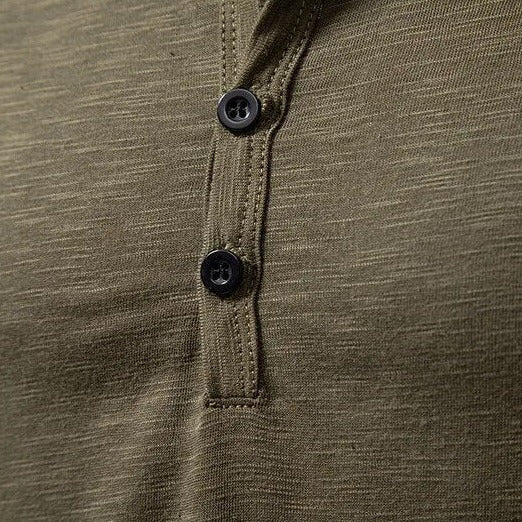 Close-up of the olive green Henley placket with dark buttons and contrast stitching 7