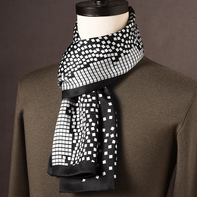 Men's black and white silk scarf with a scattered square tile pattern that fades from grid to loose squares