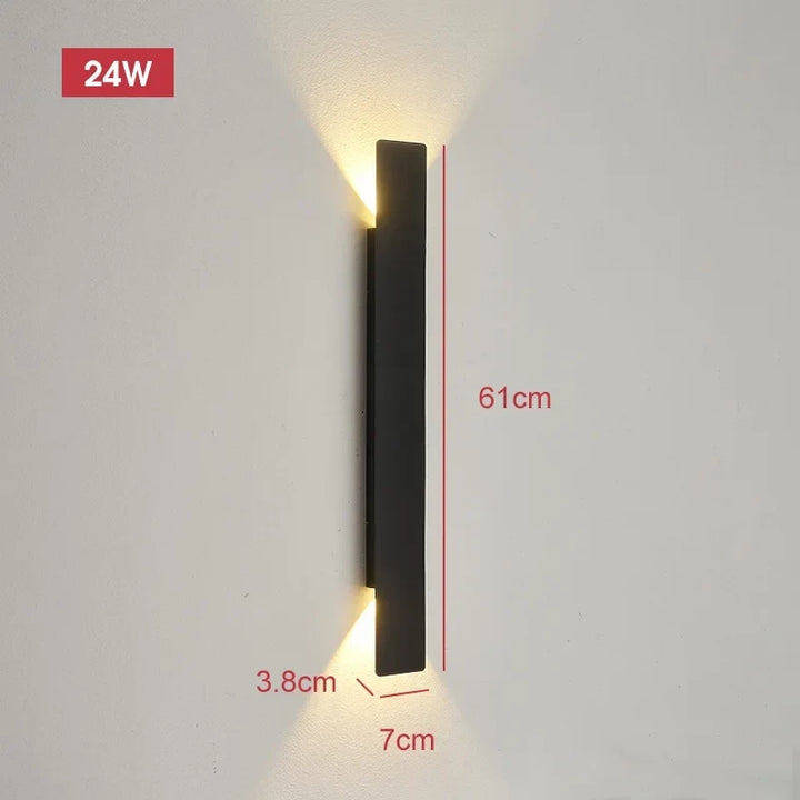 Longest black wall light on a pale wall with warm light at both ends, with dimension lines showing its size.