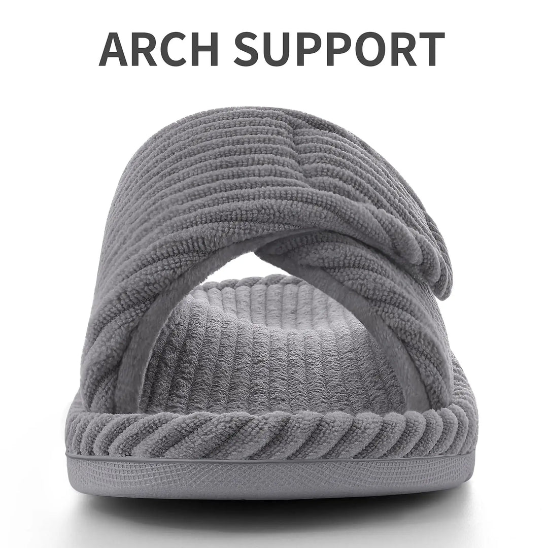 Front view of a gray corduroy slipper with a crossover strap and ribbed footbed.