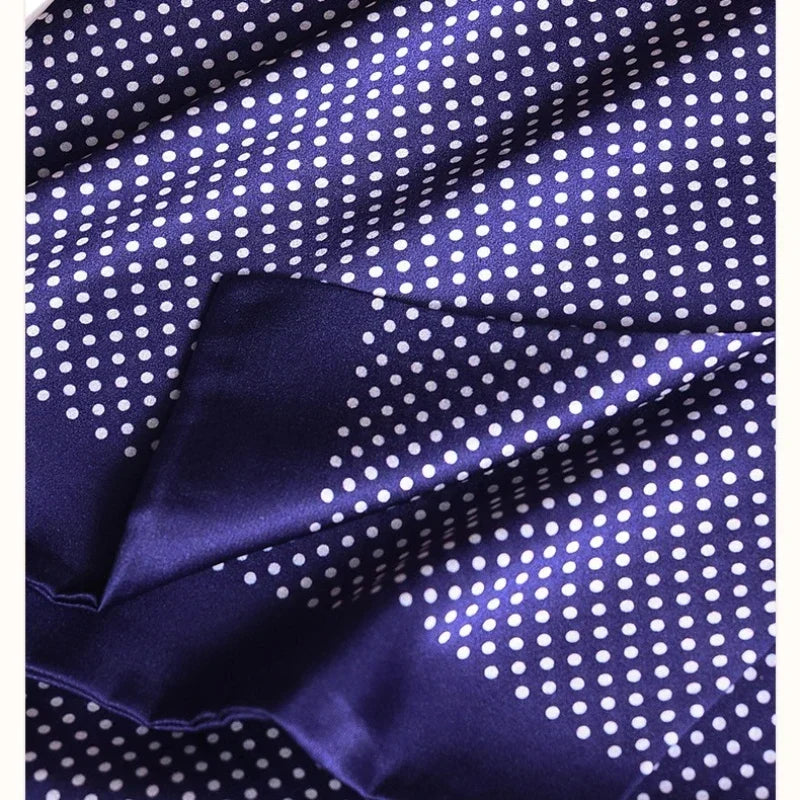 Close-up of the folded double-layer navy silk fabric with white polka dots and a smooth, glossy sheen. 27
