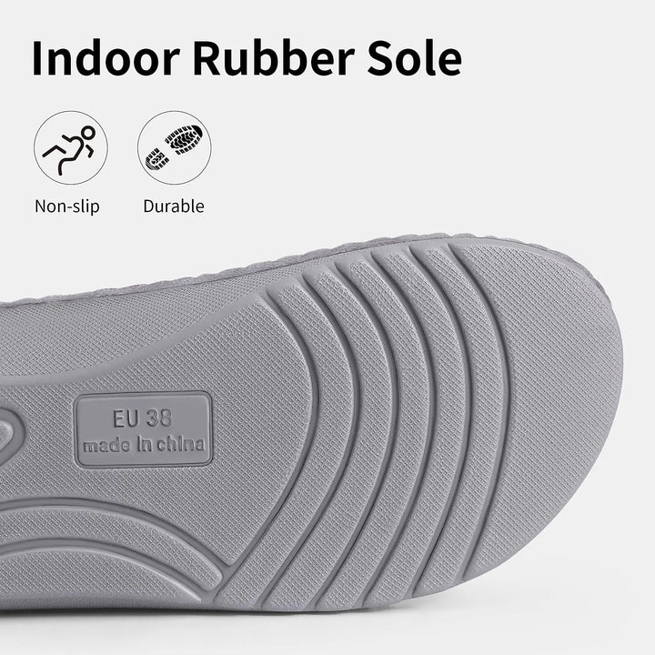 Close-up of the gray non-slip rubber outsole with curved tread grooves, a size stamp, and small non-slip and durable icons.