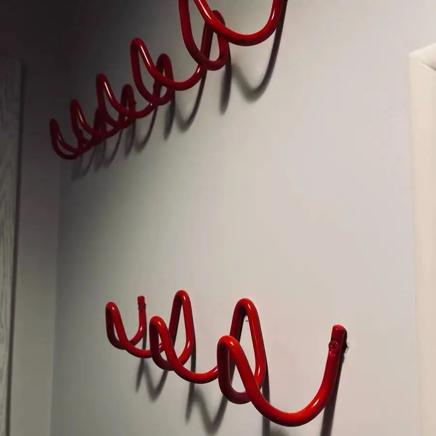 Silver metal wall rack with three hooks shown in a main photo.