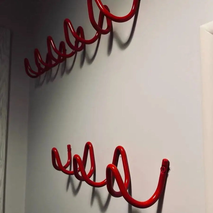 Silver metal wall rack with three hooks shown in a main photo.