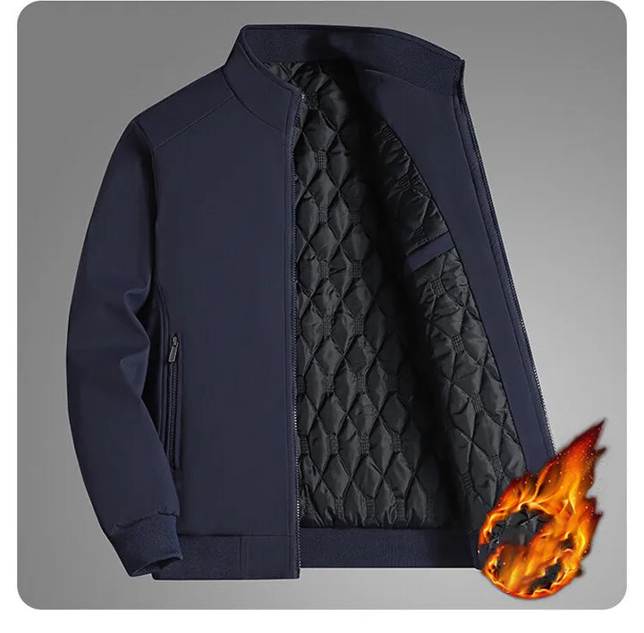 Navy blue jacket unzipped on a gray backdrop, showing the black quilted lining, ribbed trim and side zip pocket, with a flame graphic. 13