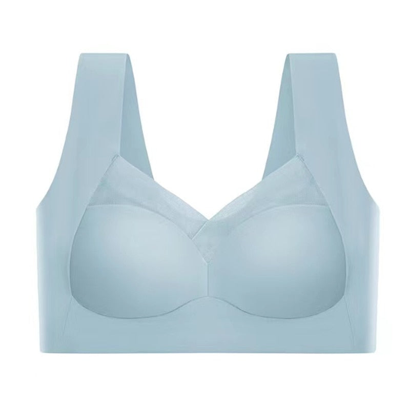 Light blue bra laid flat, front view with molded cups, mesh-trimmed V-neckline, and wide shoulder straps.