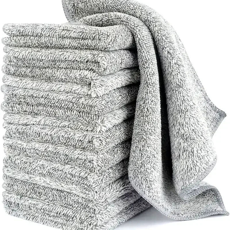 Grey microfiber cleaning cloths stacked with one draped over the side.