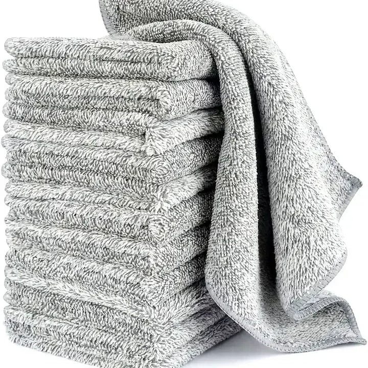Grey microfiber cleaning cloths stacked with one draped over the side.