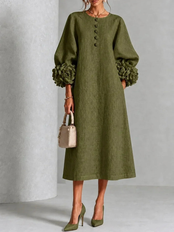 Model wears the olive green version of the midi dress with floral buttons, large rose cuffs on the puffed sleeves and green pumps. 6