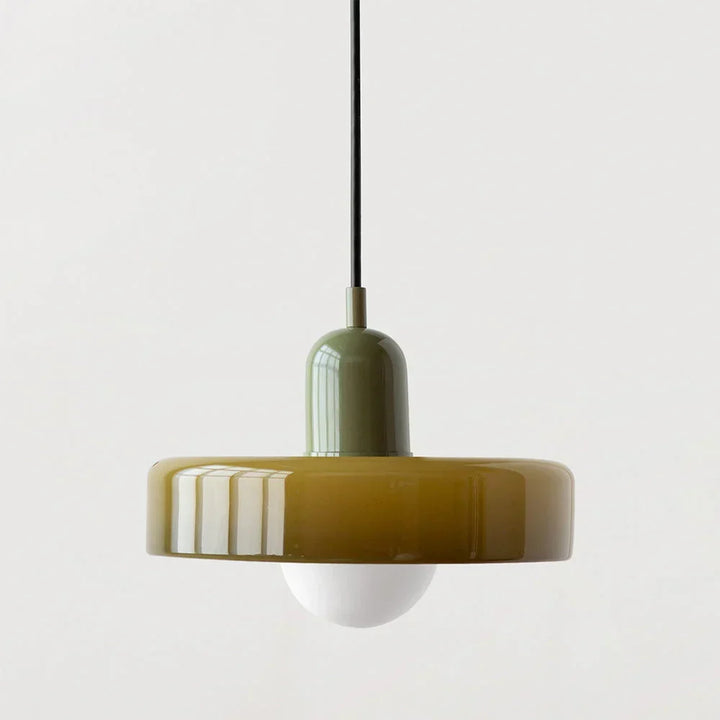 Olive glass disc shade with a sage green capsule cap, black cord and frosted globe bulb hanging below. 22