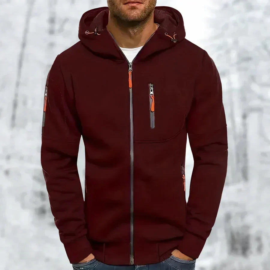 Man wearing the burgundy zip-up hoodie with orange zipper pulls, hood drawcords and a chest zip pocket.