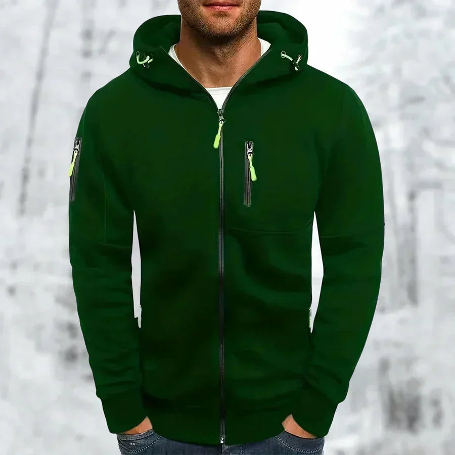Man wearing the dark green zip-up hoodie with lime green zipper pulls and drawcord ends.