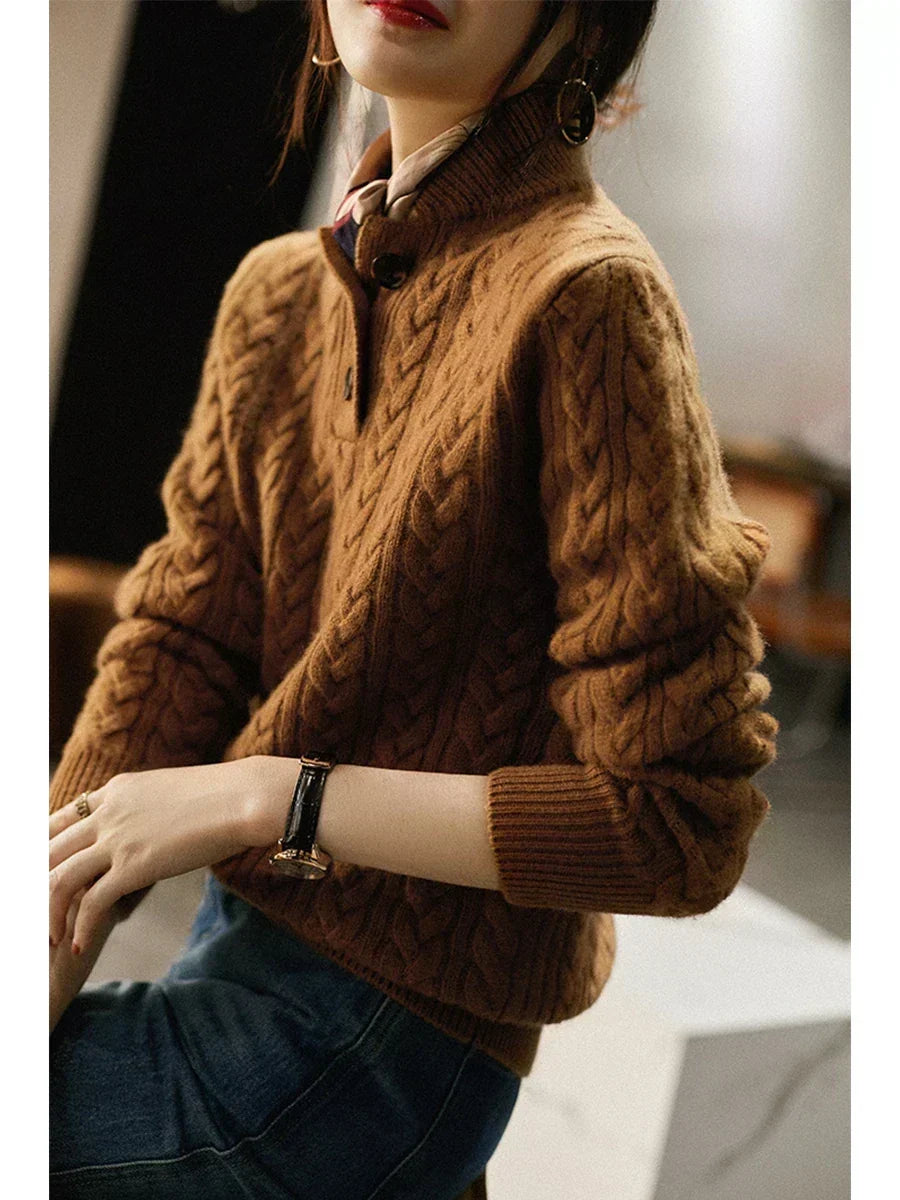 Side view of the caramel brown cable-knit sweater on a seated model, showing the sleeve cable pattern and ribbed cuff. 5