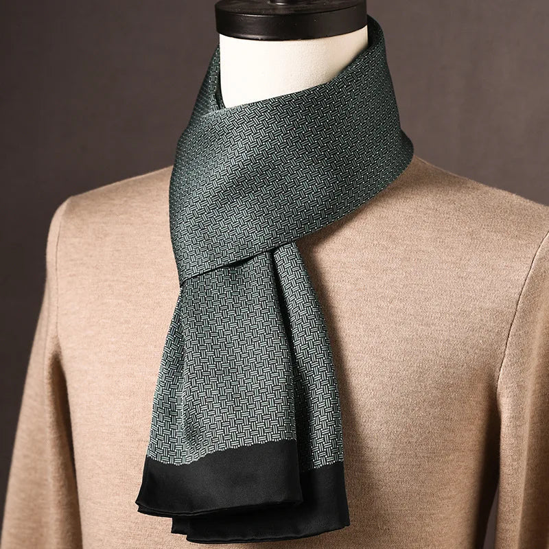 Dark green silk scarf with a fine woven-look print and a wide black edge, draped on a mannequin over a tan sweater. 23