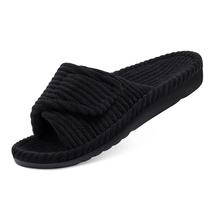 Black corduroy open-toe slide slipper with a folded adjustable strap, shown at an angle on a white background.