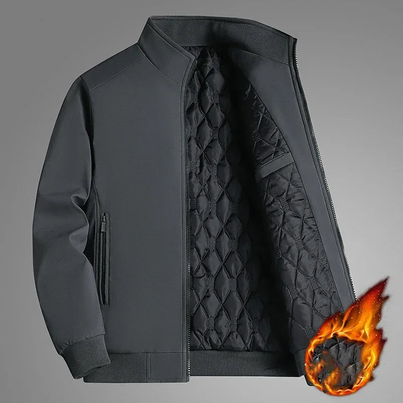 Gray version of the stand-collar jacket unzipped to reveal the quilted lining, with a flame graphic on a gray background suggesting warmth. 2