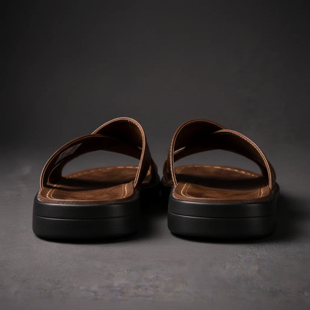 Rear view of brown crossed-strap sandals showing the thick black sole and heel edge of the footbed. 5