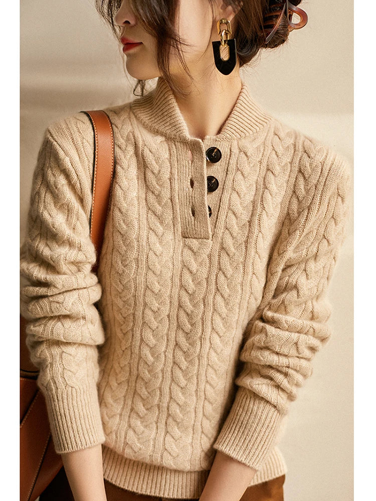 Close-up of the beige cable-knit sweater on a model with statement earrings, showing the three-button placket and ribbed cuffs. 11