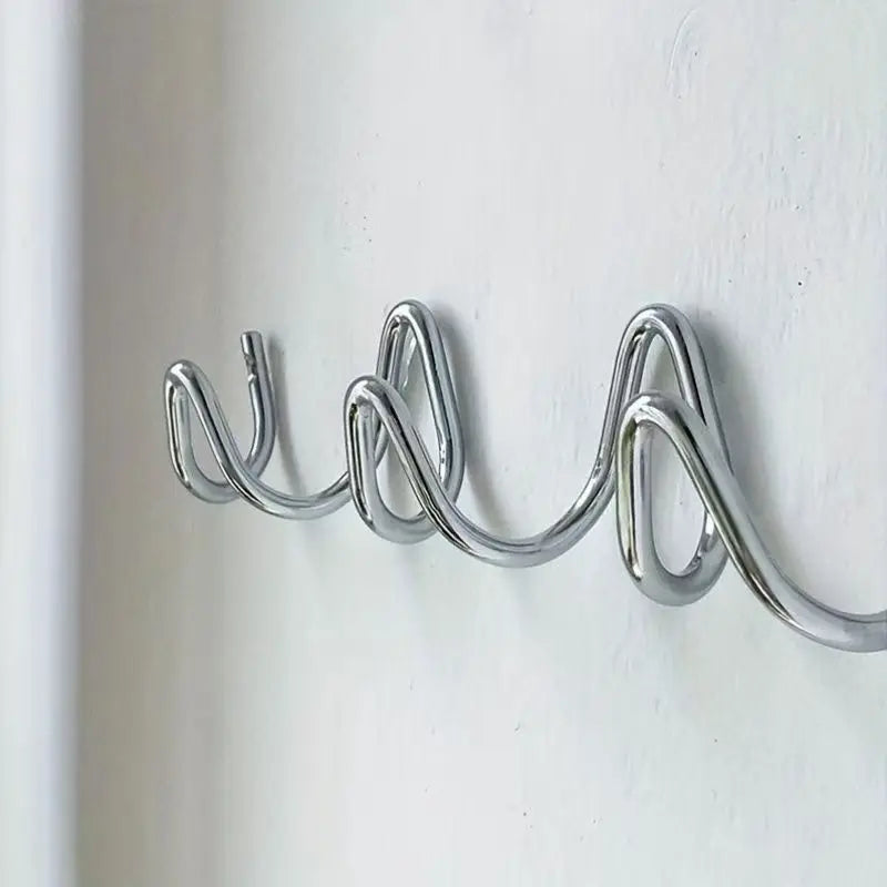 Silver metal wall rack detail showing the hook curves.