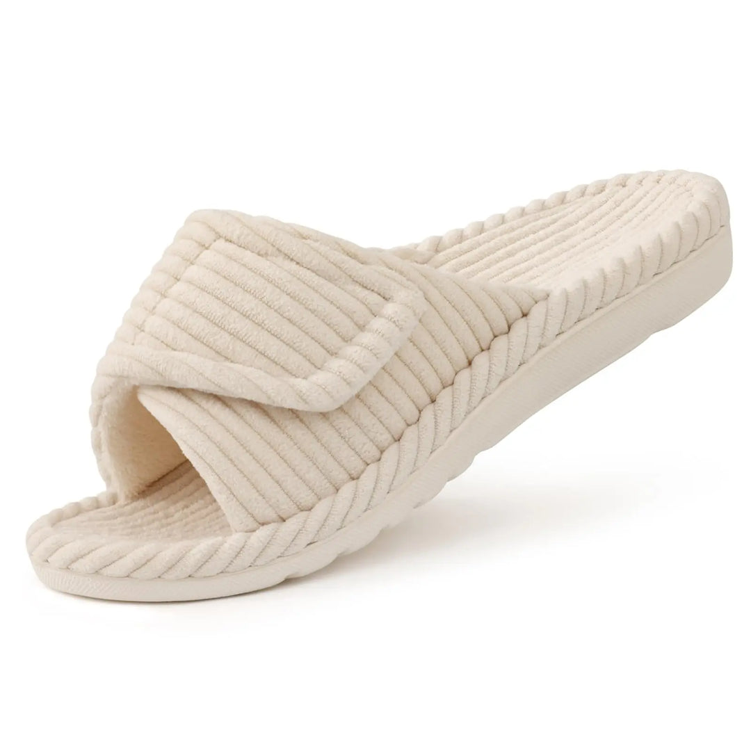 Cream corduroy open-toe slide slipper with an adjustable strap, shown at an angle on a white background.