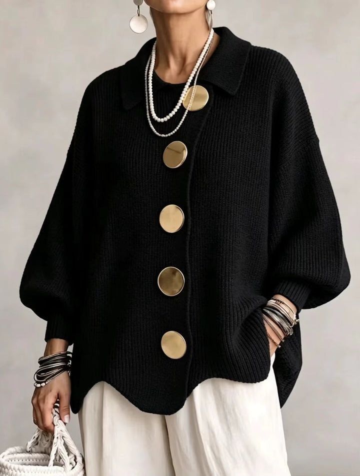 Black cardigan detail with a polo collar, large gold buttons and a scalloped hem.