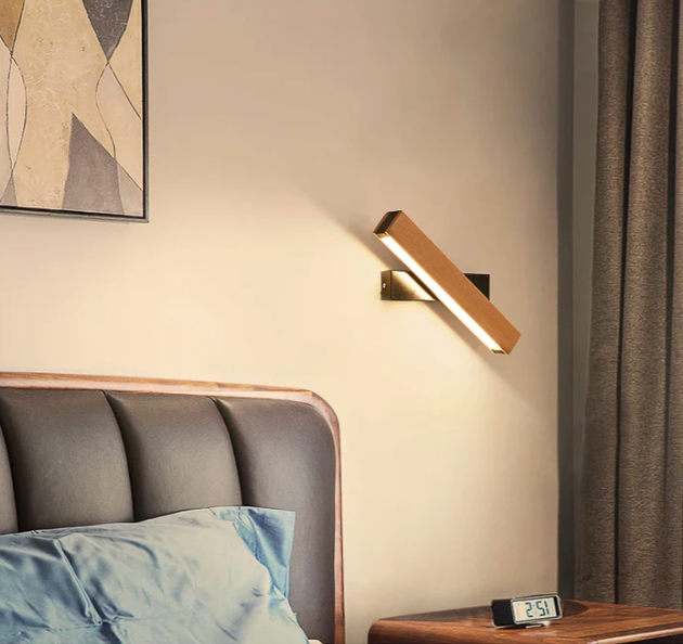 Beige and white Japanese-style LED wall light on a black mount, another view beside a padded headboard.
