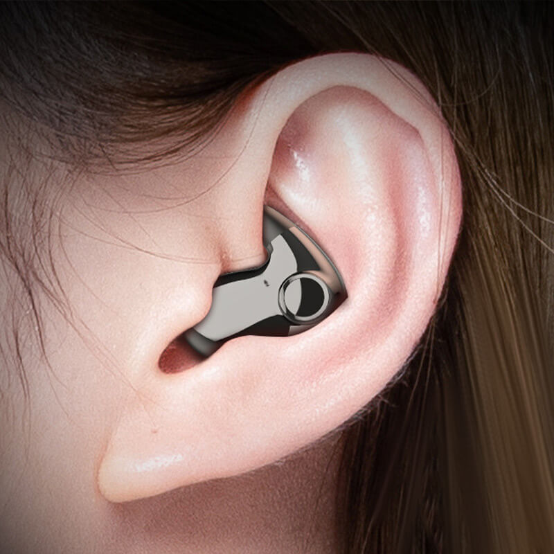 Black in-ear sleep earbuds in a woman's ear, close-up.
