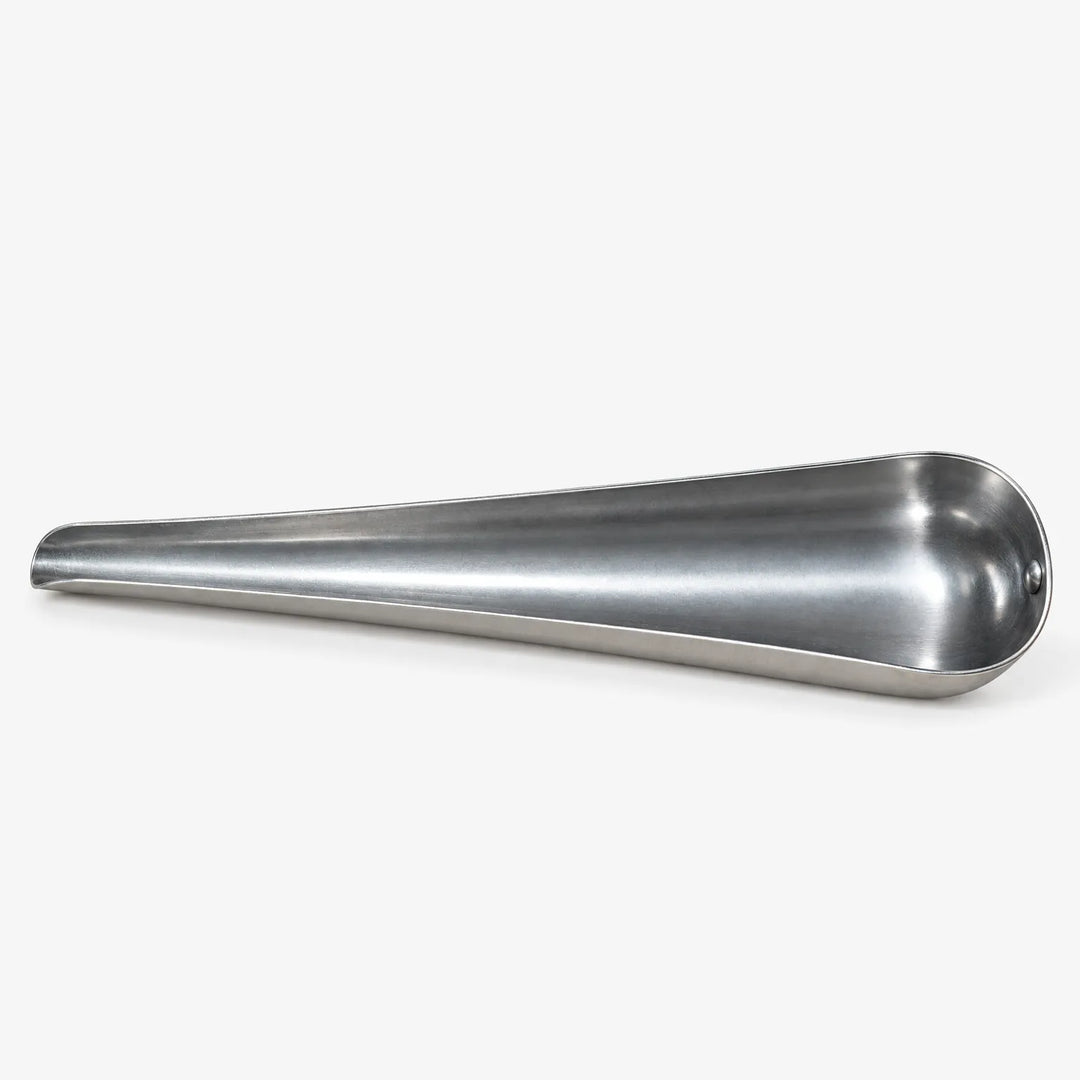 Empty tapered metal scoop lying on its side, showing its narrow pouring tip and wide, smooth, curved interior on white. 4