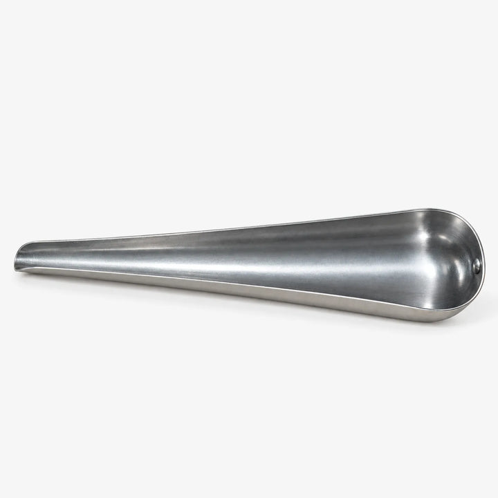 Empty tapered metal scoop lying on its side, showing its narrow pouring tip and wide, smooth, curved interior on white. 4