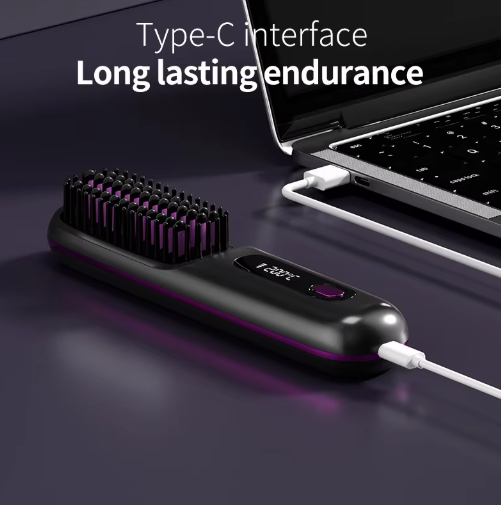 Black brush lying flat with a charging cable plugged into its end, the other cable end connected to a laptop.