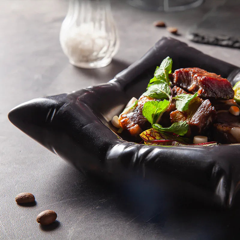 Black bowl detail with a glossy folded corner and ridged edge.