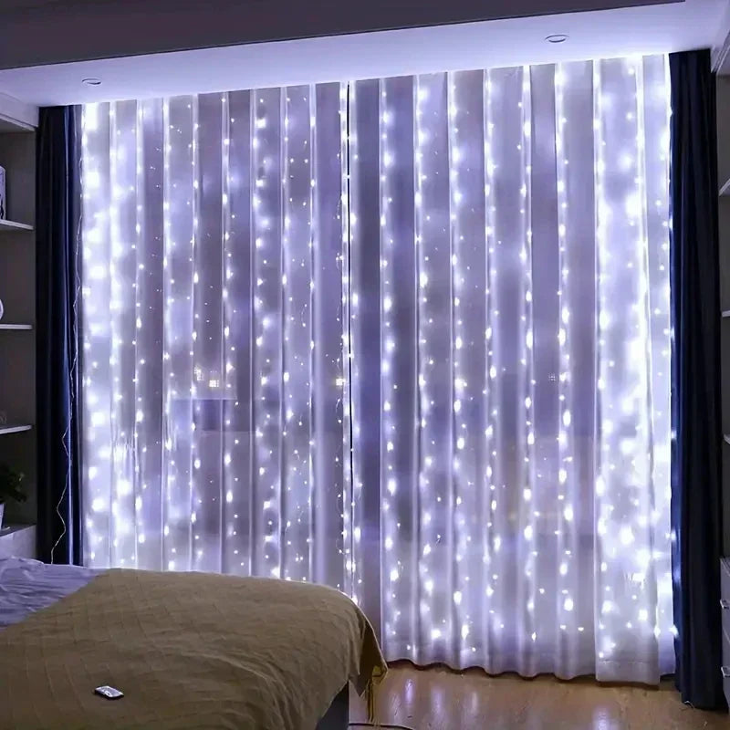Cool white curtain lights hanging over sheer curtains in a bedroom, with the remote lying on the bed. 7