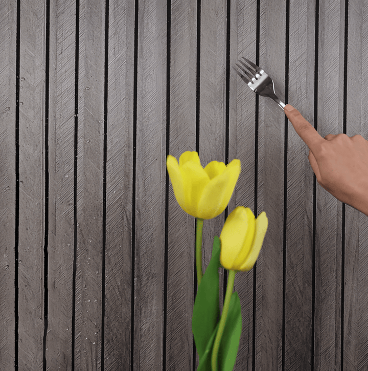 Self-adhesive wood panels in gray with a textured surface and a hand holding a fork.