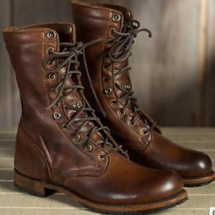 Pair of brown leather lace-up boots from the front and side, laced to the top with metal eyelets and dark laces. 3