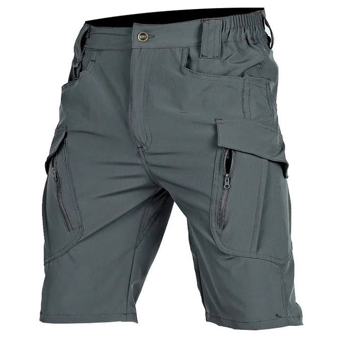 Another view of gray cargo shorts with button closure, elastic side waistband, flap pockets, and zippered pocket openings.