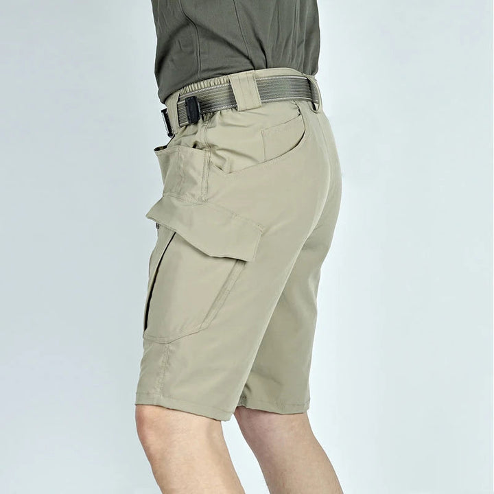 Another view of khaki cargo shorts with a webbing belt, showing the large cargo pocket and side seam.