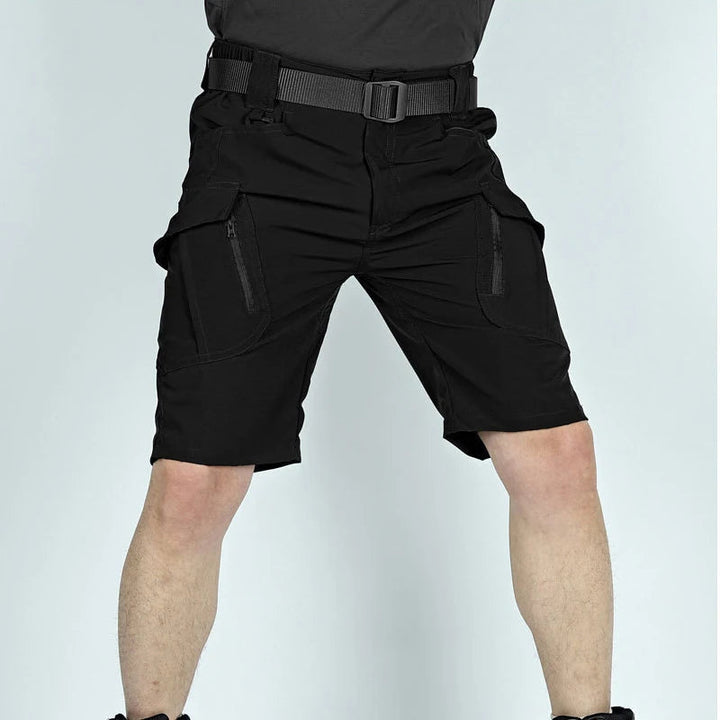 Another view of black cargo shorts with a black belt, showing the zippered cargo pockets on both thighs.