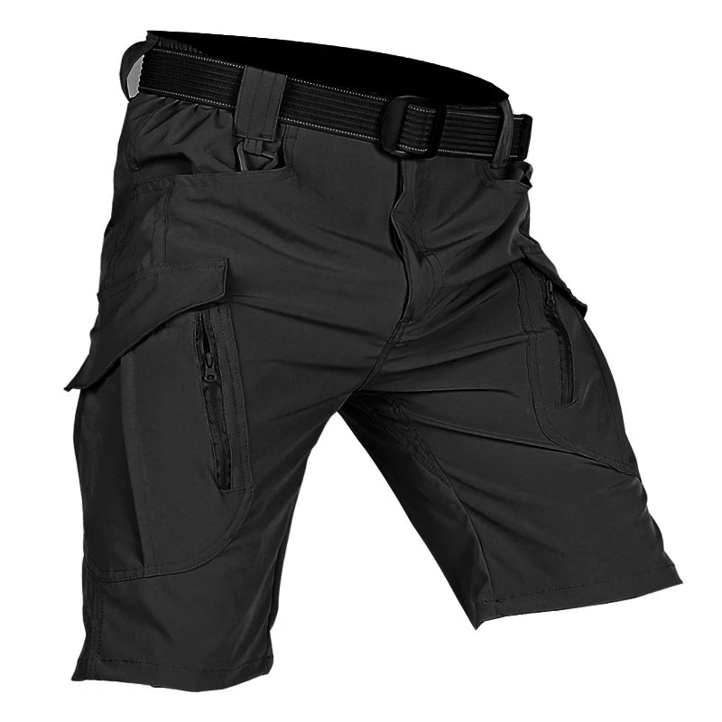 Black tactical cargo shorts with large flap pockets, zippered pocket openings, and a black webbing belt.